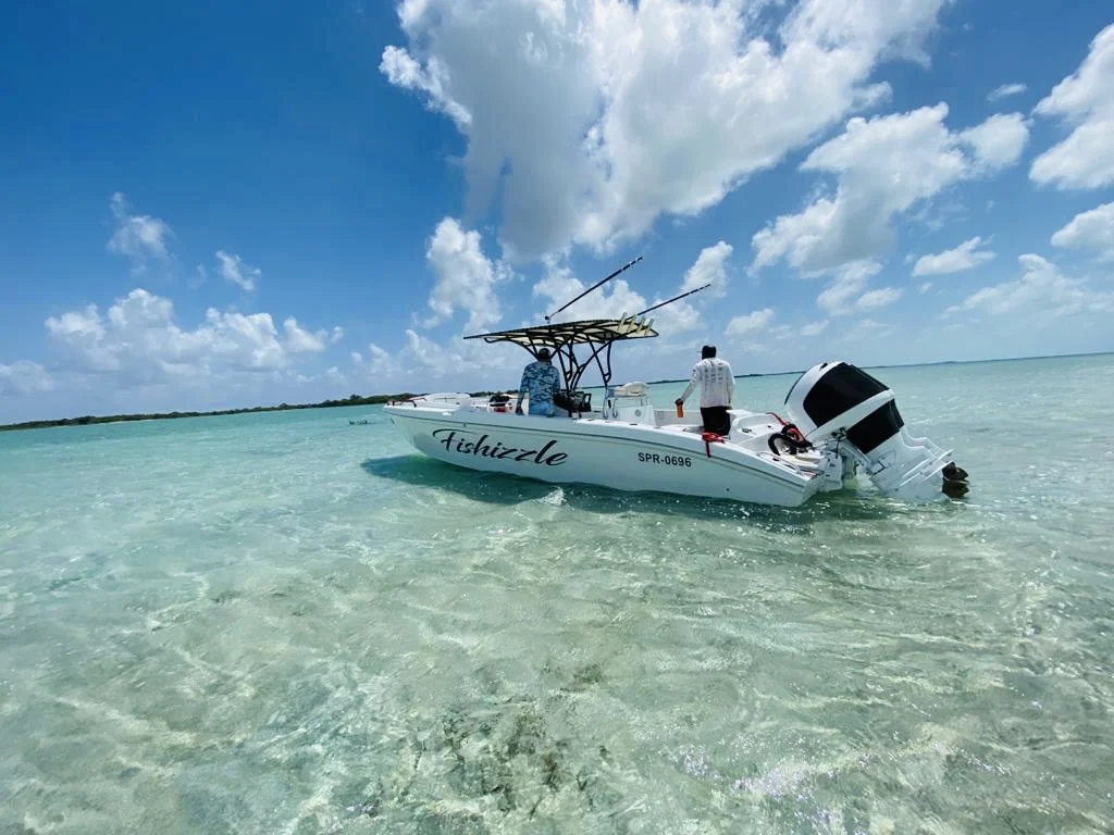 Fishizzle, the Seakarus charter boat, in the clear shallows of Belize